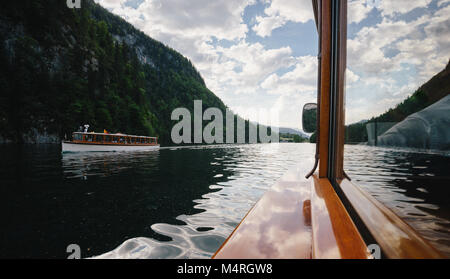 Classic view of traditional passenger boats on famous Lake Konigssee on a beautiful sunny day with blue sky and clouds in summer, Berchtesgadener Land Stock Photo