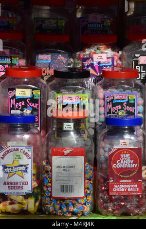 jars of sweets and sugary treats for sale in a sweet shop store or confectionery stall at a market in a high street. Sweet treats and confections jars Stock Photo