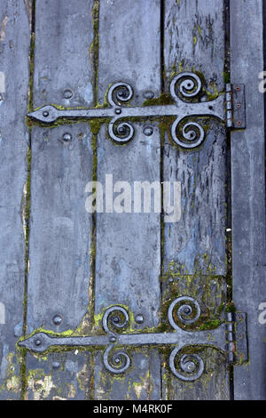 an old trap door to a beer cellar at an inn or a public house for access to the cellar from the street for draymen. hinges in ornate ironwork straps. Stock Photo