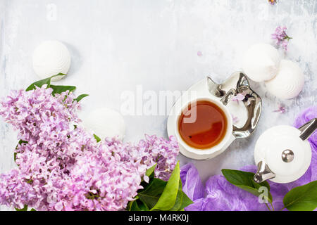 Relaxation time concept. Homemade zephyr with cup of tea on a cozy kitchen table. Copy space, top view flat lay background. Stock Photo
