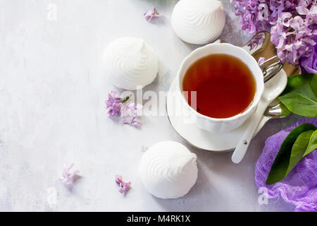 Relaxation time concept. Homemade zephyr with cup of tea on a cozy kitchen table. Copy space, top view flat lay background. Stock Photo