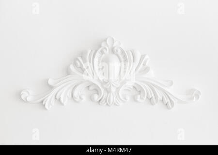 Expensive interior. Stucco elements on light luxury wall. White patterned. Mouldings element from gypsum. Roccoco style Stock Photo