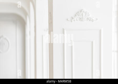 Expensive luxury interior. Stucco elements on light column. White patterned. Mouldings element from gypsum. Roccoco style Stock Photo