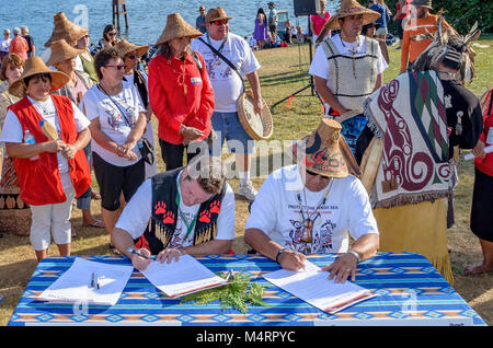 Chief Justin George of Tsleil-Waututh Nation and Chief Gibby Jacob of Squamish Nation sign a historic declaration to protect the Salish Sea.Many Peopl Stock Photo