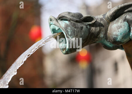 Manchester, UK. 17th Feb, 2018. A Gargoyle spouting water with Chinese lanterns in the background, Manchester, 17th February, 2018 (C)Barbara Cook/Alamy Live News Stock Photo