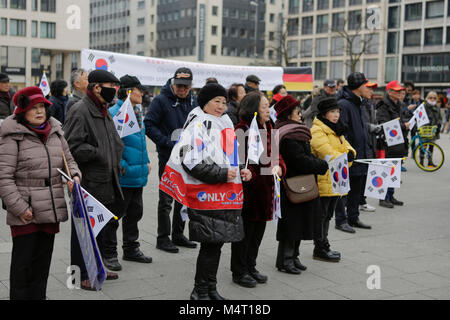 Frankfurt, Germany. 17th February 2018. People are pictured at the rally, holding South Korean flags. South Koreans living in Germany protested in Frankfurt in support of former president Park Geun-hye, calling for her release and for the impeachment of her successor Moon Jae-in. Credit: Michael Debets/Alamy Live News Stock Photo