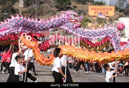 Los Angeles, USA. 17th Feb, 2018. Dragon dancers perform during the 119th 'Golden Dragon Parade' held to celebrate the Chinese Lunar New Year in the streets of Chinatown in Los Angeles, the United States, Feb. 17, 2018. Credit: Zhao Hanrong/Xinhua/Alamy Live News Stock Photo