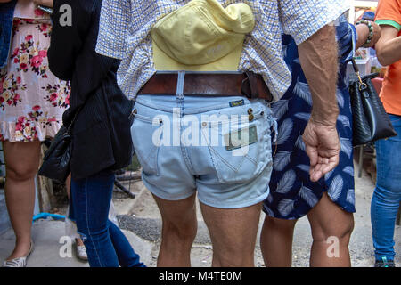 Man wearing denim shorts outdoors. Stock Photo