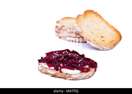 Healthy toast with feta cheese beetroot and sesame seeds on a plate, over white background Stock Photo