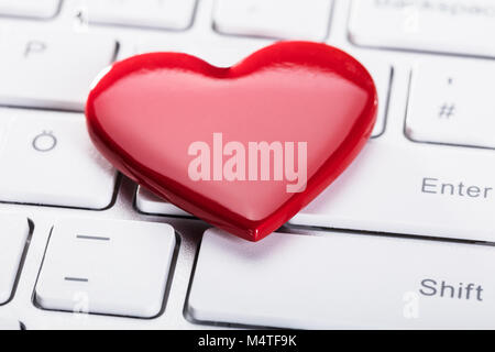 Elevated View Of Red Heart Shape On White Keyboard Stock Photo