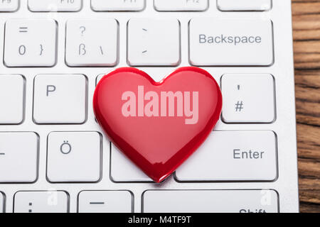 Elevated View Of Red Heart Shape On White Keyboard Stock Photo
