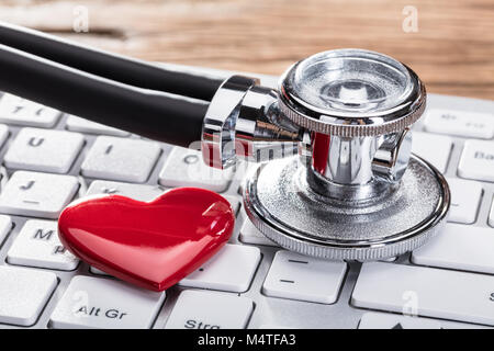 Close-up Of A Stethoscope And Heart Shape On White Keyboard
