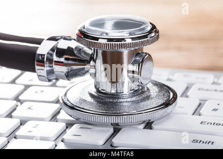 Close-up Of A Stethoscope On White Computer Keyboard Stock Photo