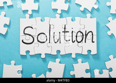 Elevated View Of Solution Word Made With Puzzle Over Blue Background Stock Photo