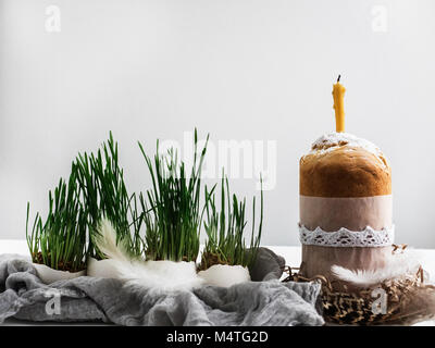 Fragrant cupcake on a background of fresh, green grass in pots. Preparing for Easter Stock Photo