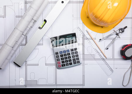 Architectural Scale Ruler with paper blueprints plans for new building ...