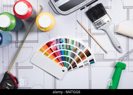 High Angle View Of Color Guide Swatch On Blueprints With Paint Roller And Paint Brush Stock Photo