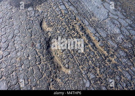 Cracked road surface. Stock Photo