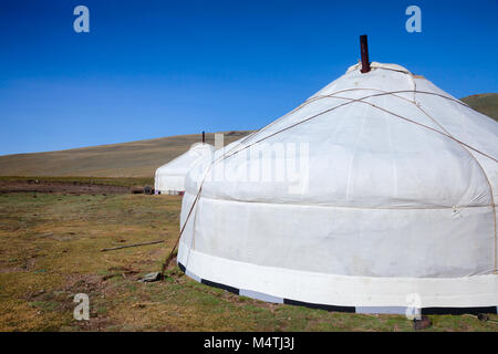 Traditional Mongolian portable round tent ger covered with white outer cover in Altai Mountains of Western Mongolia Stock Photo