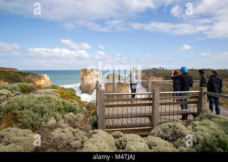 Melbourne, Australia: April 02, 2017: Tourists take photographs from the viewing platforms overlooking the iconic Loch Ard Gorge at Port Campbell Park Stock Photo