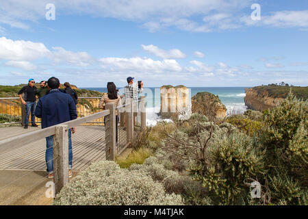 Melbourne, Australia: April 02, 2017: Tourists take photographs from the viewing platforms overlooking the iconic Loch Ard Gorge at Port Campbell Park Stock Photo