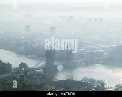 A cold and frosty dawn with air pollution over London's skyline with Tower Bridge and the Docklands Stock Photo