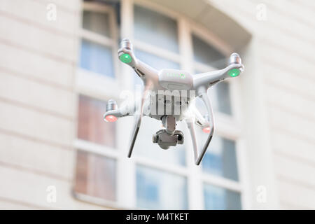 Low angle view of drone spying through house window Stock Photo
