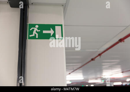 Emergency exit sign at entrance of underground parking lot Stock Photo