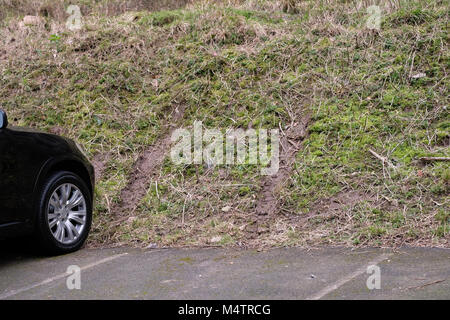February 2018 - Tyre tracks left in the earth bund by a 4x4 SUV owner showing off in one of  the car parks in Cheddar Gorge, Somerset, England. Stock Photo