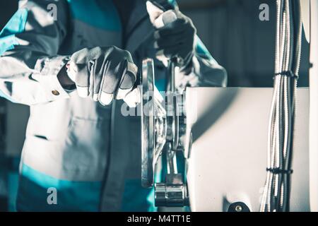 Metal Lathe Worker Adjusting Machine. Metalworking Industry Theme. Stock Photo