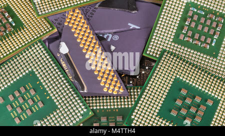 Broken obsolete processor among the new modern ones. Heap of computer chips. Technological progress, digitization, virtualization, hacking danger. Stock Photo