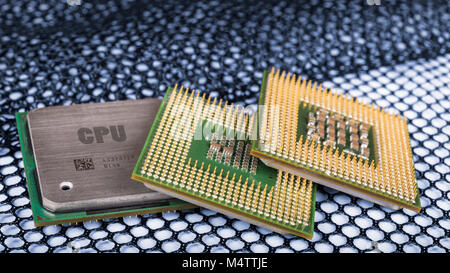 Computer processors on hexagonal textured mesh. Modern central processing units. Idea of ICT, cyber security, meltdown and spectre attacks. Stock Photo