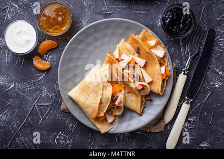 Pancakes crepes with different fruits and chocolate Stock Photo