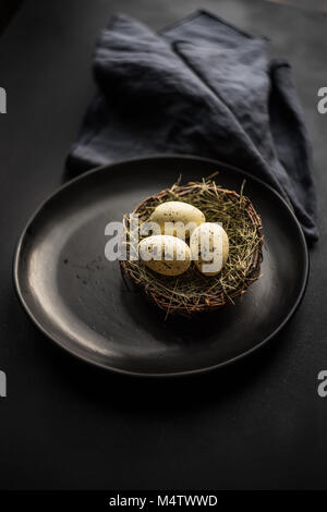 Table setting for festive Easter dinner on white rustic wooden table with copyspace Stock Photo