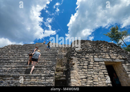 Caracol, Cayo District, Belize - March 22, 2015: Tourists climb the stairs of Caana pyramid at Caracol archaeological site of Maya civilization, Weste Stock Photo