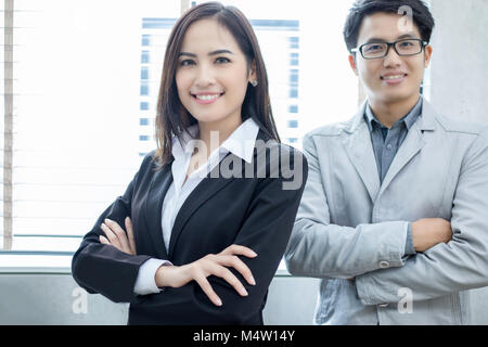 Asian businesswomen and group using notebook for business partners discussing documents and ideas at meeting and business women smiling happy for work Stock Photo