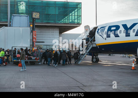 Passengers boarding a Ryanair jet after their new cabin bag policy came into effect - requiring them to forfeit their baggage to loading crews Stock Photo