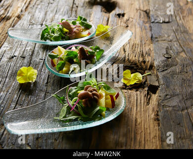 Appetizer of baby octopus. Sea food. Film effect. Stock Photo