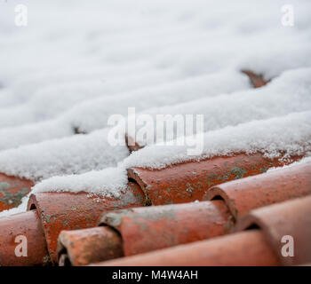 roof with ancient shingles covered in snow Stock Photo