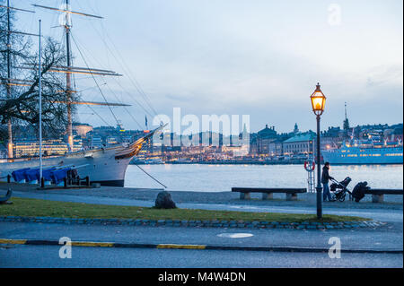 People enjoy a Sunday walk during autumn at Skeppsholmen island in Stockholm. The capital city of Sweden is built on 17 islands. Stock Photo