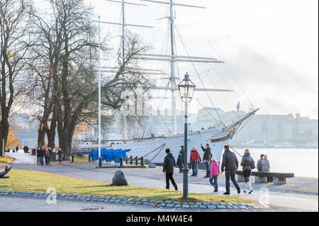 People enjoy a Sunday walk during autumn at Skeppsholmen island in Stockholm. The capital city of Sweden is built on 17 islands. Stock Photo