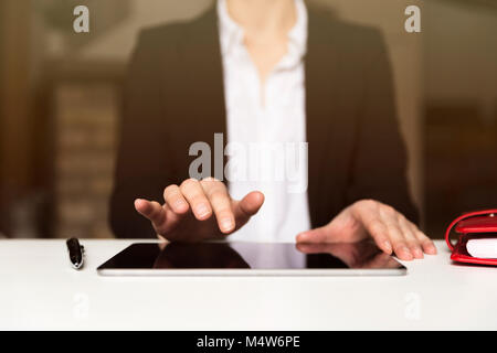 Business woman working on tablet in office Stock Photo