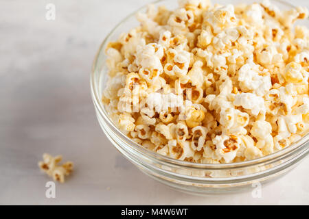 Golden caramel popcorn in glass bowl