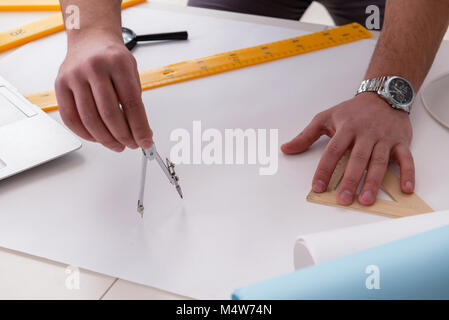 Male engineer working on drawings and blueprints Stock Photo