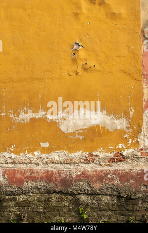 Old wall with crumbling plaster Stock Photo