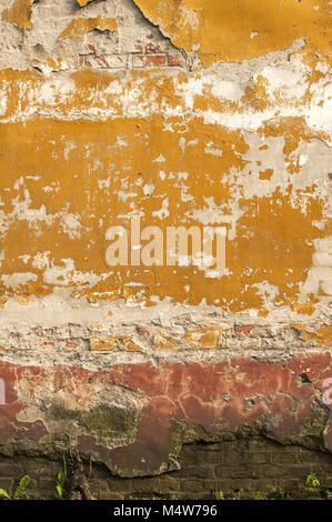 Old wall with crumbling plaster Stock Photo