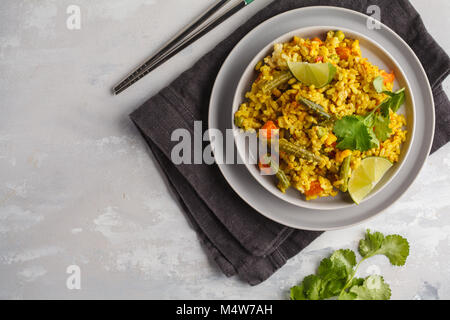 Vegetarian curry rice with vegetables in a gray plate. Healthy vegan food concept, detox. Stock Photo