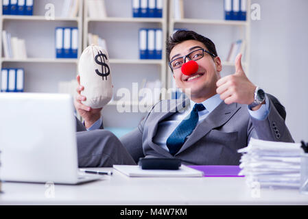 Clown businessman in the office with the a money sack Stock Photo