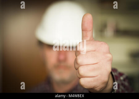 Construction worker showing hand with thumb up Stock Photo