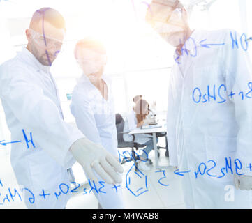 group of young scientists talking in a lab Stock Photo
